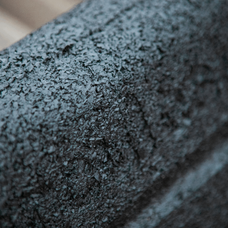 Close-up of Hercules Eco Block; Rough, textured black surface.