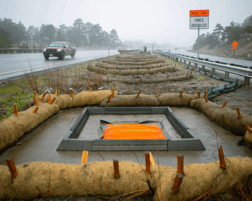 Road median with erosion barriers and Hercules Eco Blocks in square formation.